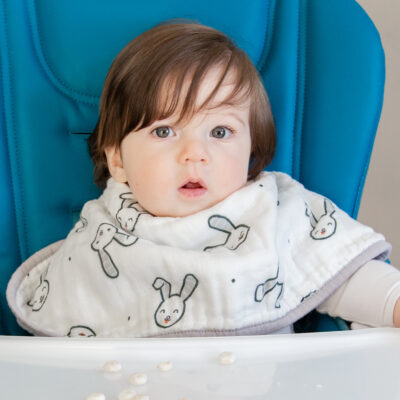 Toddler wearing the bunny bib sitting in a high chair